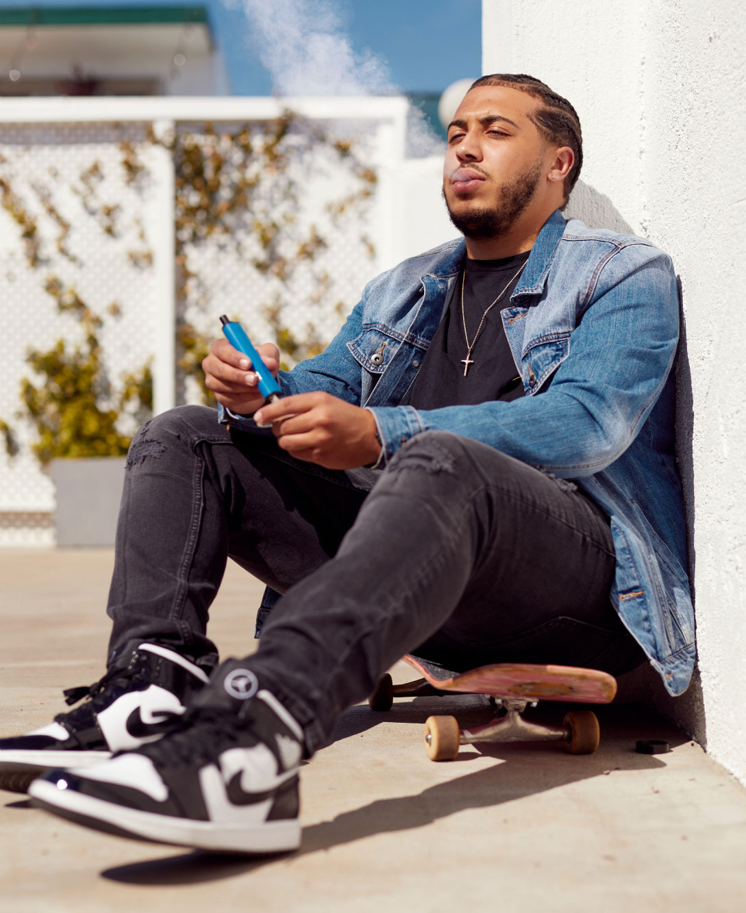 Man Sitting on Skateboards Vaping Man Sitting on Skateboard Vaping